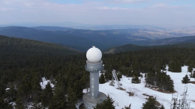 Aerial Orbit Shot of Meteorological Radar Station on Snowy Mountain Peak