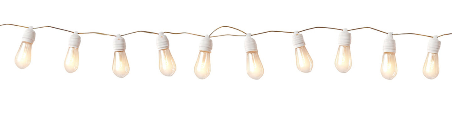A string of illuminated bulbs hanging from a light brown cable against a black background