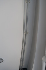 Close-up view of a sleek and contemporary ceiling cornice featuring clean lines and subtle detailing. This minimalist design adds a touch of elegance to modern interior spaces. © magpie