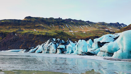 Majestic vatnajokull glacier in iceland with massive ice cap and frost floating on arctic lake, icelandic scenic route. Beautiful nordic nature with polar icebergs snowy mountains. © DC Studio