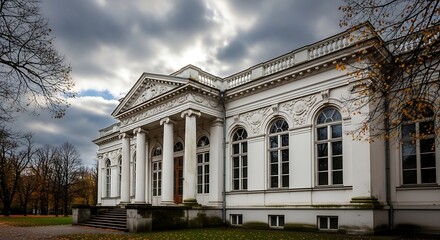 Fototapeta premium Hauntingly beautiful abandoned mansion under dramatic cloudy skies