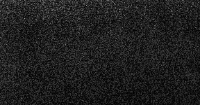 A black texture featuring a dense cluster of small, irregularly shaped oval bumps