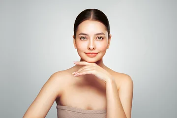 Portrait beautiful young woman with clean fresh skin. Model with healthy skin looks at an empty space, close up portrait. Cosmetology, beauty and spa © Oleg Gekman