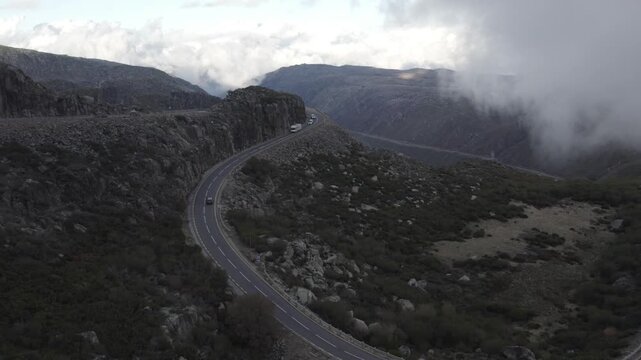 EN339 hairpin near Torre in Serra da Estrela Seia municipality Guarda district Centro region Portugal showing constant radius switchback with vehicles as drone fly towards traffic