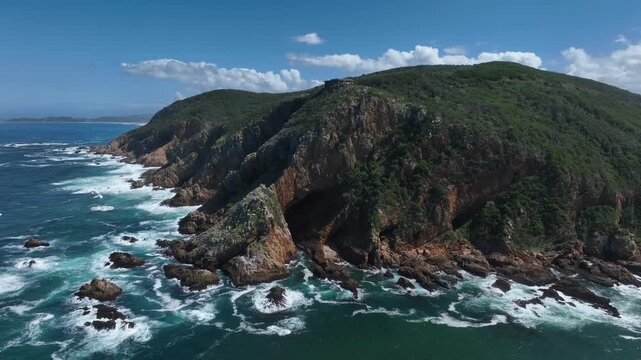 Pan left aerial view of Knysna Heads in Featherbed Nature Reserve in Knysna, South Africa.