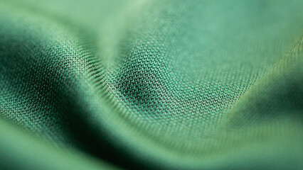 Green sports clothing fabric football shirt jersey texture close up © Kwangmoozaa