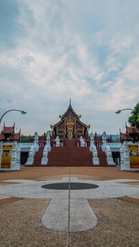 Traditional Thai temple in Rajapruek park with symmetrical pathway and statues in Chiang Mai, Ornate Asian shrine architecture with stairs and cultural landmark in Thailand