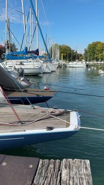 Boat moored beside a wooden dock on Lake Annecy, France, at the end of September, conveying quiet marina routine and peaceful European lakeside travel.