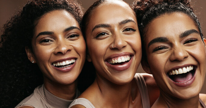 Smile, women and friends with makeup in studio for beauty, natural glow and inclusion. Portrait, people and laughing with funny joke, facial cosmetics and makeover for aesthetic on brown background