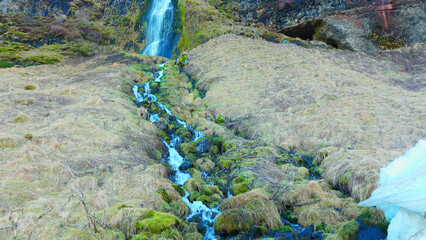 River stream from scandinavian cascade flowing down off of hill, water flow running off cliff in iceland. Beautiful seljalandsfoss waterfall in reykjavik, arctic landscape. Handheld shot. © DC Studio