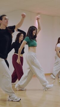Young women learning hip hop choreography in dance class