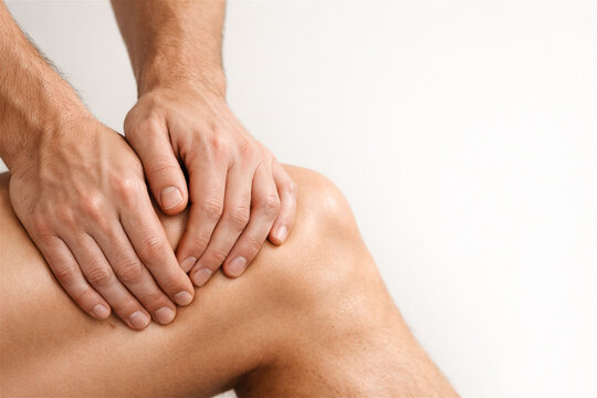 man holding his knee with hand. Patient feeling joint pain or injury. Healthcare concept for medical treatment, orthopedic assessment, sport trauma recovery and rehabilitation therapy