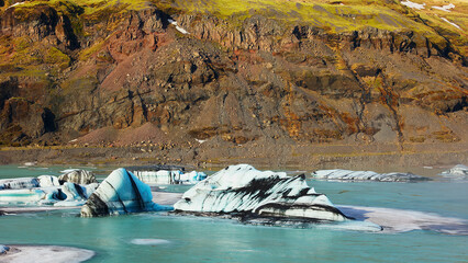 Massive polar vatnajokull ice cap in iceland, beautiful large glacier colored with white, blue and green. Frozen floating icebergs in cold winter landscape and natural arctic scenery, icy land. © DC Studio