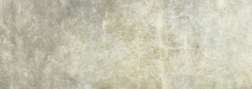 Panoramic old dirty rough beige wall surface with grunge texture, featuring wide format cracked, stained, and weathered concrete details, ideal for abstract wallpaper, banner, industrial background.