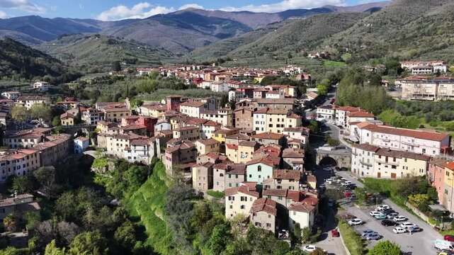 Aerial view of the historic town of Loro Ciuffenna with terracotta rooftops nestled among the green hills and mountains of the Apennines Reggello, Tuscany, Italy.