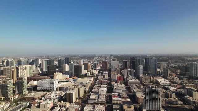 Wide aerial drone shot flying north above downtown San Diego at 9AM capturing the full city skyline.