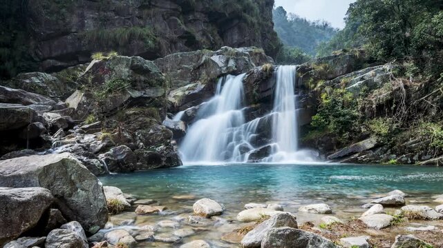 Time-lapse of the silky twin waterfalls cascade through a lush valley, captured via slider with ND filter for silky water and dynamic retreat perspective.