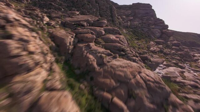 A cinematic FPV drone flight over unique smooth rock formations at Kolymbithres Beach on Paros island, Greece. Natural sculpted stones create an unusual landscape, perfect for travel, nature 
