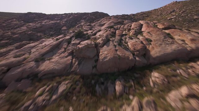 A cinematic FPV drone flight over unique smooth rock formations at Kolymbithres Beach on Paros island, Greece. Natural sculpted stones create an unusual landscape, perfect for travel, nature 