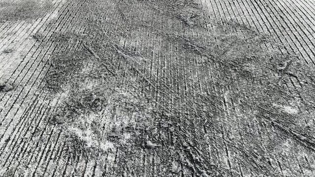Rough Concrete Texture with Grooves and Grime - Close-up View of Ground Surface