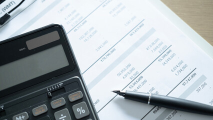 Close up of calculator and pen on financial statement document, business accounting, budget analysis and corporate report concept. © Jokiewalker