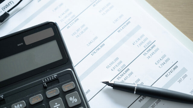 Close up of calculator and pen on financial statement document, business accounting, budget analysis and corporate report concept.