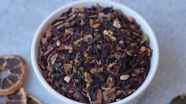Dry herbal or fruit tea with flower petals and aromatic additives. Dry fruit herbal tea as a background for your design