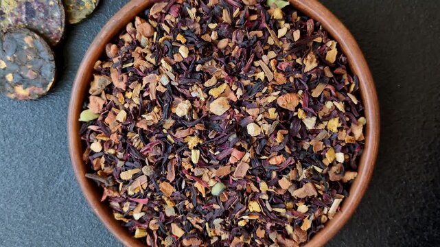Dry herbal or fruit tea with flower petals and aromatic additives. Dry fruit herbal tea as a background for your design