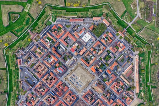 Aerial view of the star-shaped fortress with its intricate network of moats and ramparts, a testament to military architecture, Neuf-Brisach, Grand Est, France.