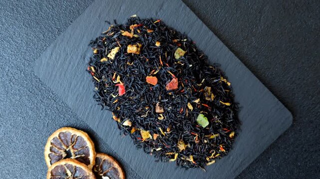 Dry black tea with herbal leaves and aromatic additives. Dry fruity black tea as a background for your design