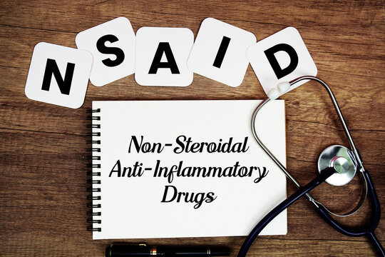 NSAID Non-Steroidal Anti-Inflammatory Drugs text written on notepad with stethoscope on wooden background