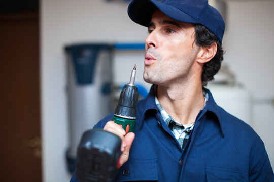 Handyman considering task with power drill