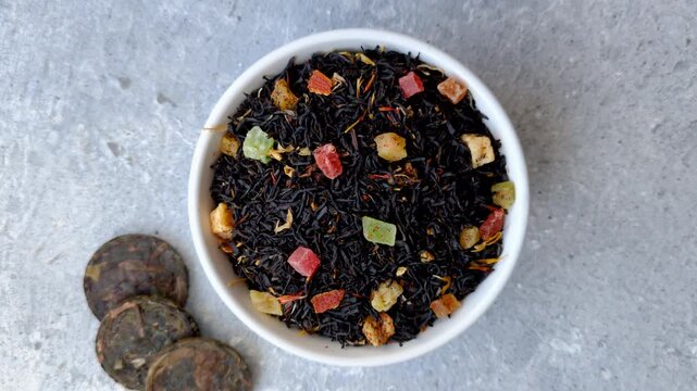 Dry black tea with herbal leaves and aromatic additives. Dry fruity black tea as a background for your design