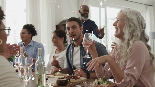 Male guest starting toast at table guests clapping celebrating food star sparkles over wine board