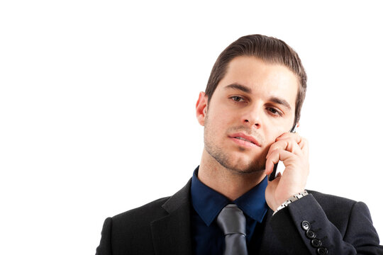 Professional young man in a suit engaging in a phone conversatio