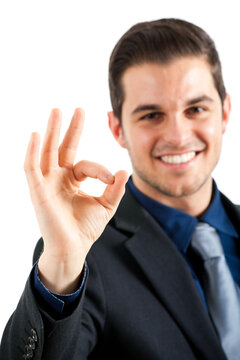 Confident businessman giving okay gesture