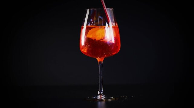 Refreshing aperol spritz cocktail with orange slice and ice, cinematic close-up footage.