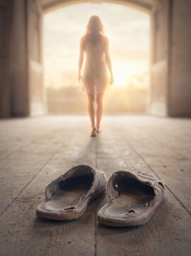 Woman walking toward bright light through open door leaving old worn shoes behind, concept of new beginning and life transformation