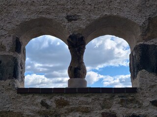 Weathered sculpture under open sky. Carved stone guardian overlooking distant valley landscape © Vladimir