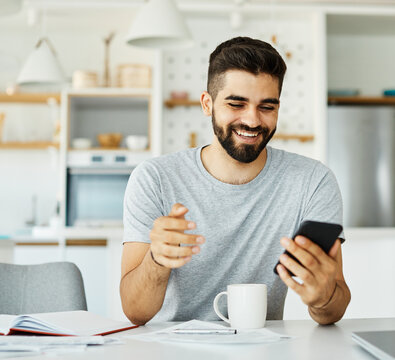 Portrait of a young man with a smartphone at home