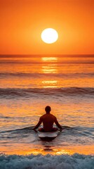 Fototapeta premium Surfer meditating on surfboard during ocean sunset
