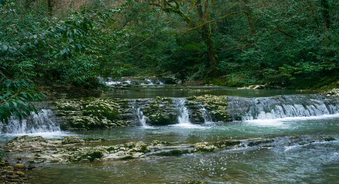 cascade of waterfalls in mountain forest