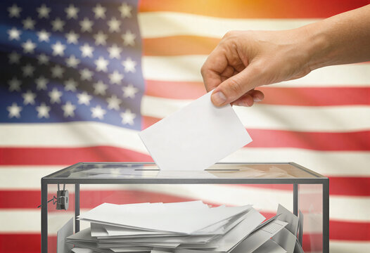 Hand casting a ballot into a transparent glass box in front of an American flag, voting rights and democracy concept for election and civic participation