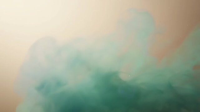 A swirling cloud of turquoise ink disperses in a soft, warm-toned liquid.