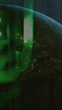 Vertical video: View panning Earth rotating green aurora spreading flares lighting cities tech demo
