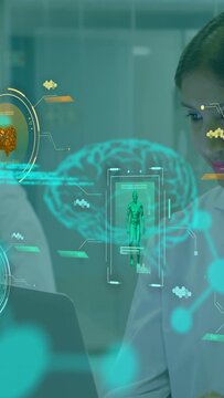 Vertical video: Lab scientist gazing at laptop starting AR brain scan and code for clinical study