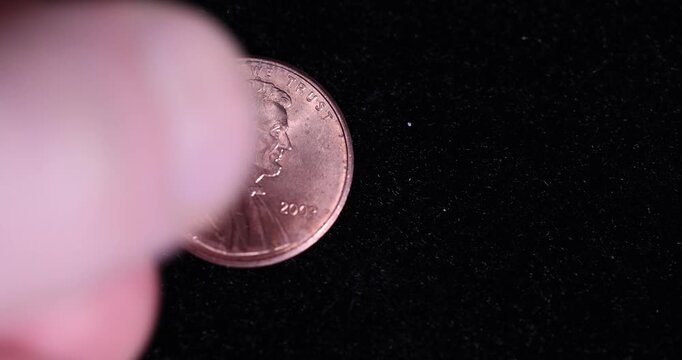 an American one-cent coin on black velvet, an old one-cent coin on a black soft surface, close up