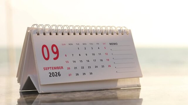 Slow motion footage of flip calendar pages for change months from august to september of the year 2026. concept of planning and starting a new month. 4k horizontal.