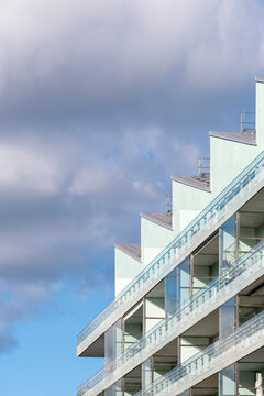 Minimal modern architecture building facade skyline cityscape focused on terrace geometry and sharp angles under wide sky clouds background with editorial calm