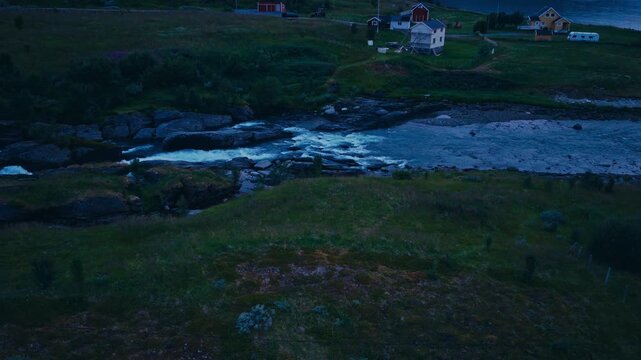 Kokelv, Hammerfest, Finnmark, Norway - A River Winds Through the Landscape, With Houses Scattered Along the Grassy Hills - Aerial Drone Shot
